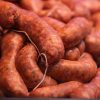 Homemade pork sausages grouped ready for consumption, selective focus on the center of the image.
