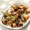 Mediterranean escargot delicacy snails with rosemary and garlic oil